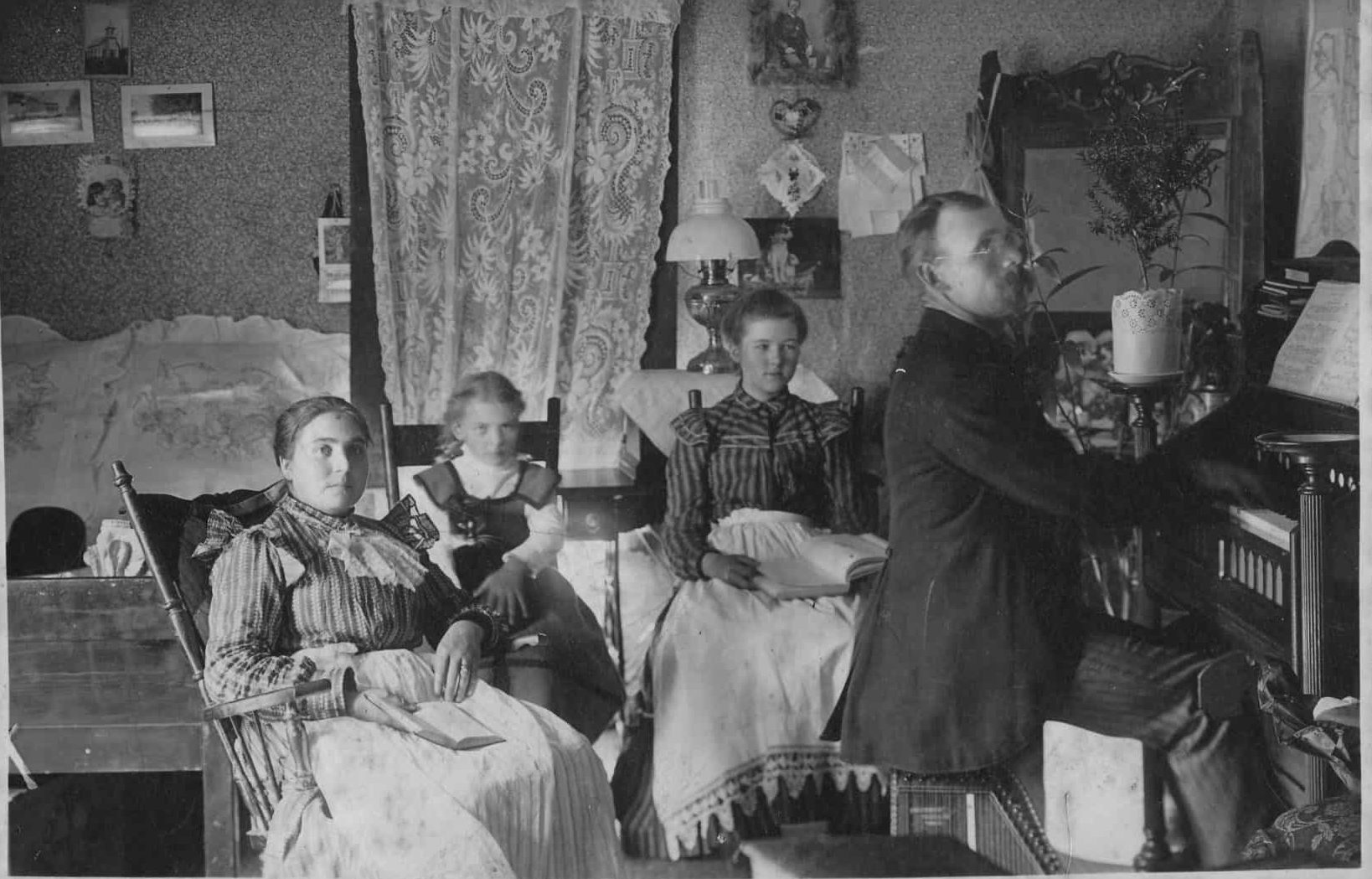 Photo of the Olin family sitting around the organ at home